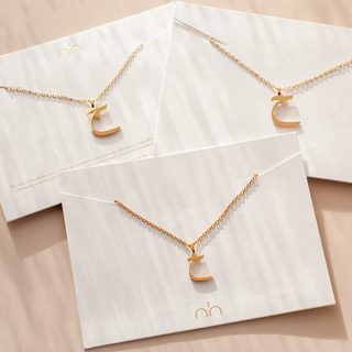 Nimah Arabic Letter Necklace In Gold Showing Three Variations Of The Same Letter 